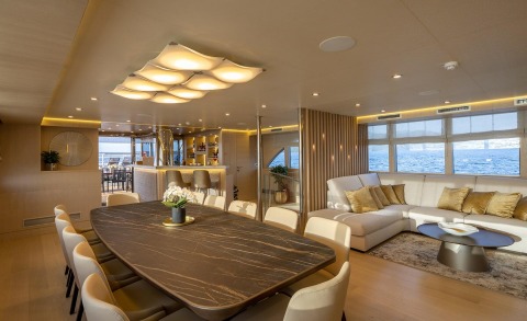 Love Story 43m luxury yacht interior: marble dining table, beige seating, bar area, ocean view windows