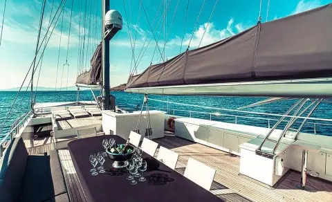 Virtuoso yacht deck at sunset with shaded seating area and blue sea
