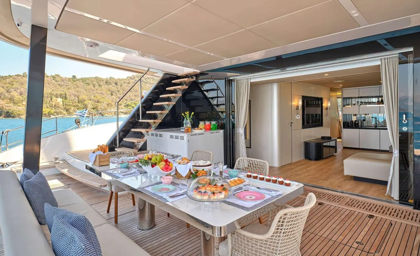 Genny yacht dining deck on a sunlit luxury gulet with table settings