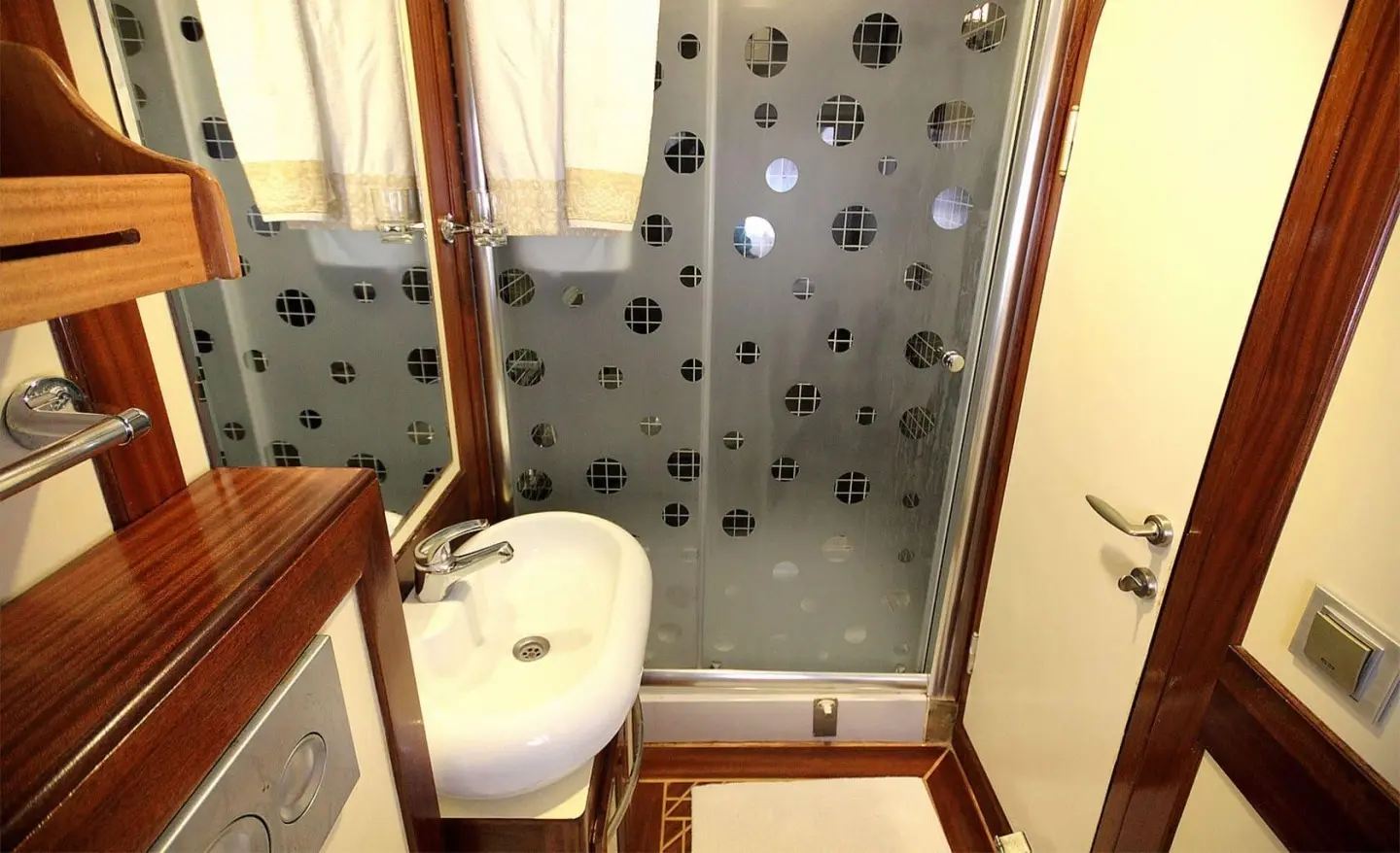 Compact interior of Angelo II gulet with bathroom and shower stall visible