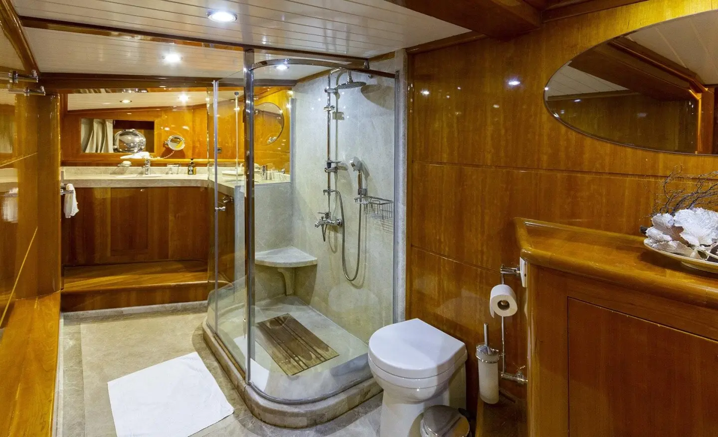 Silver Moon yacht interior with wooden panels, glass shower, and compact bathroom