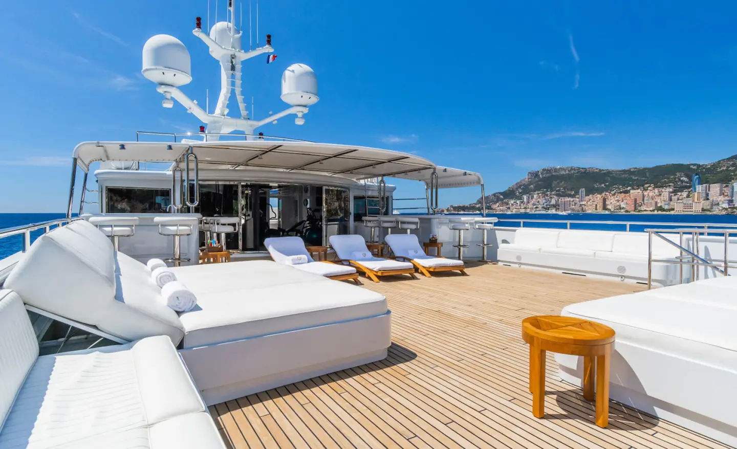 Apogee yacht flybridge with seating and a small table on deck