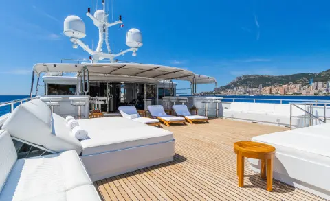 Apogee yacht flybridge with seating and a small table on deck