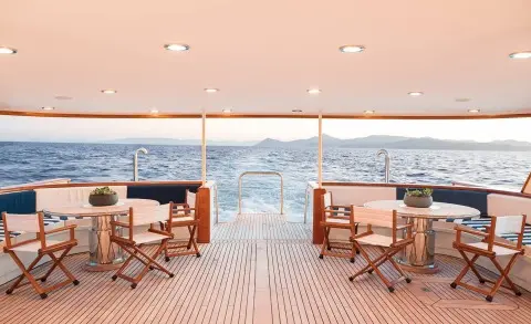 Wind Of Fortune aft-deck with seating, wooden deck, railings, ocean view