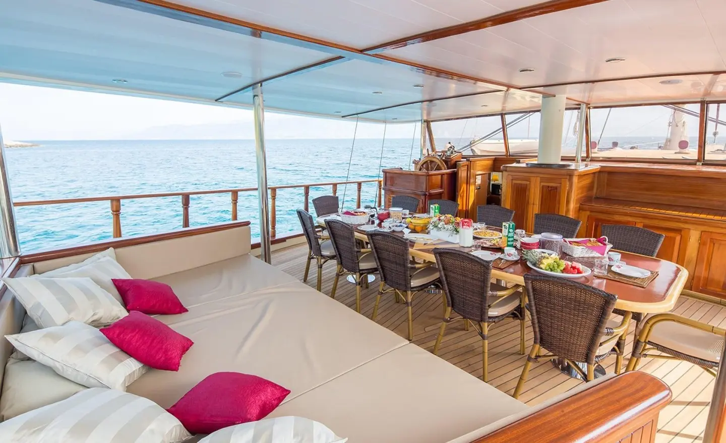 Morning Star aft deck on a gulet, seating area with table and cushions, sunlit sea view