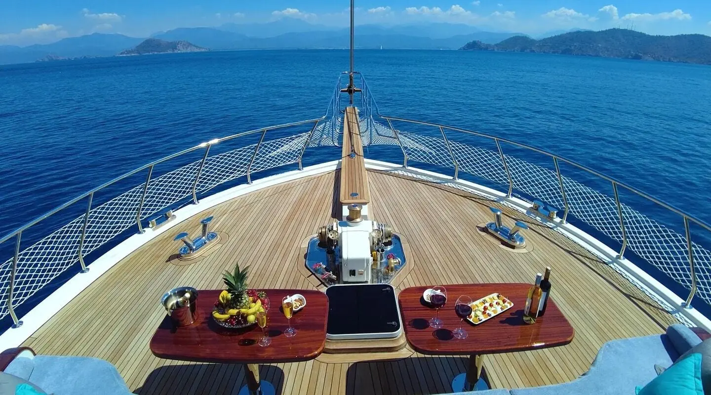 From the bow of Maya, a luxury gulet sails at sunset over calm blue sea