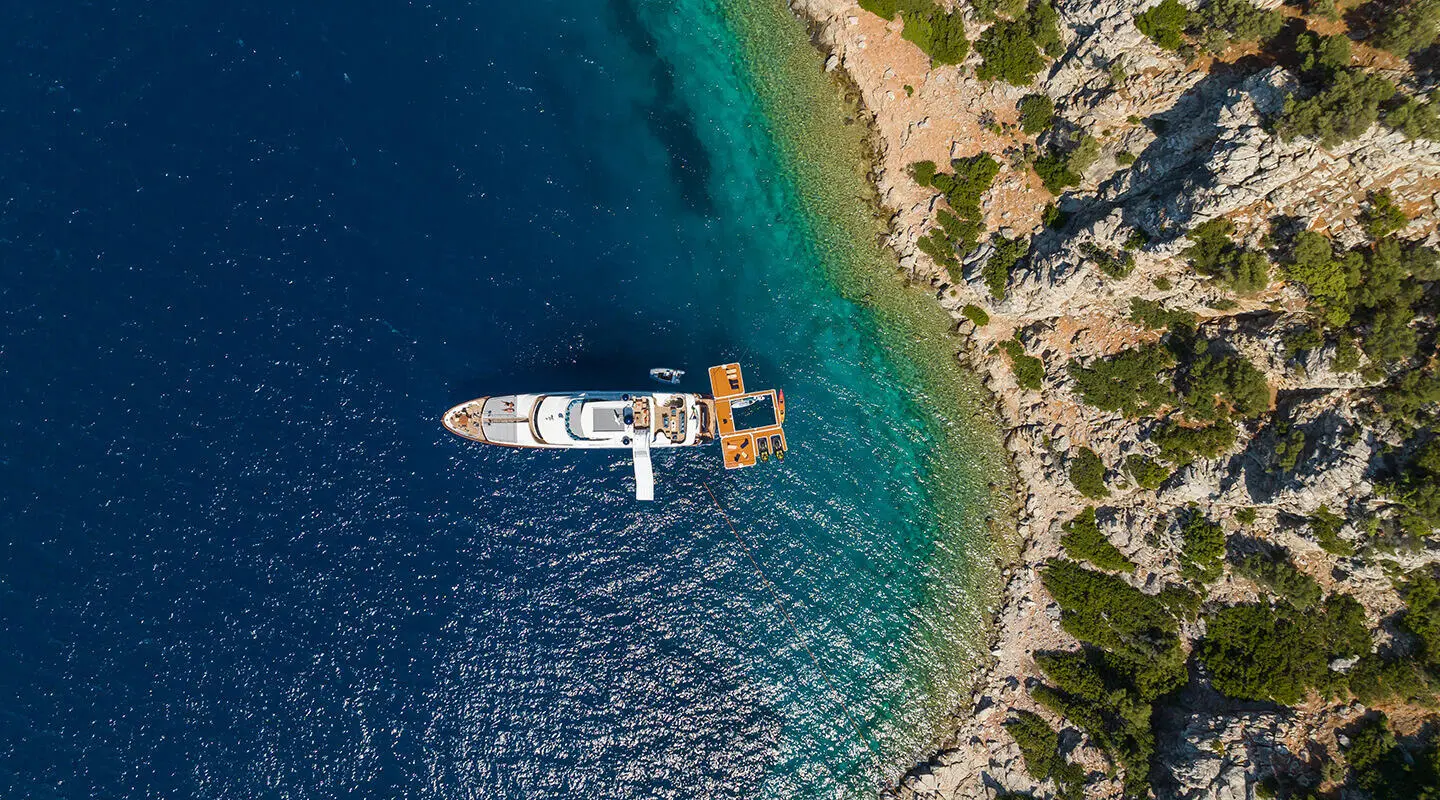 Amadea yacht seen from above anchored by coast