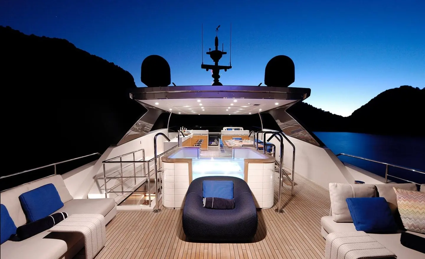 Morning Star yacht deck at sunset with seating and helm, calm sea