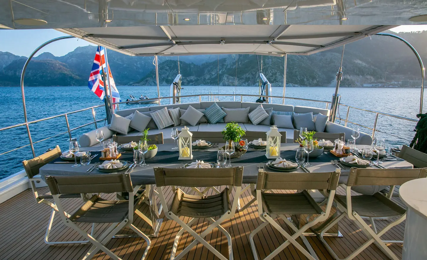 aft deck of the Good Life gulet with wooden chairs and dining setup under canopy