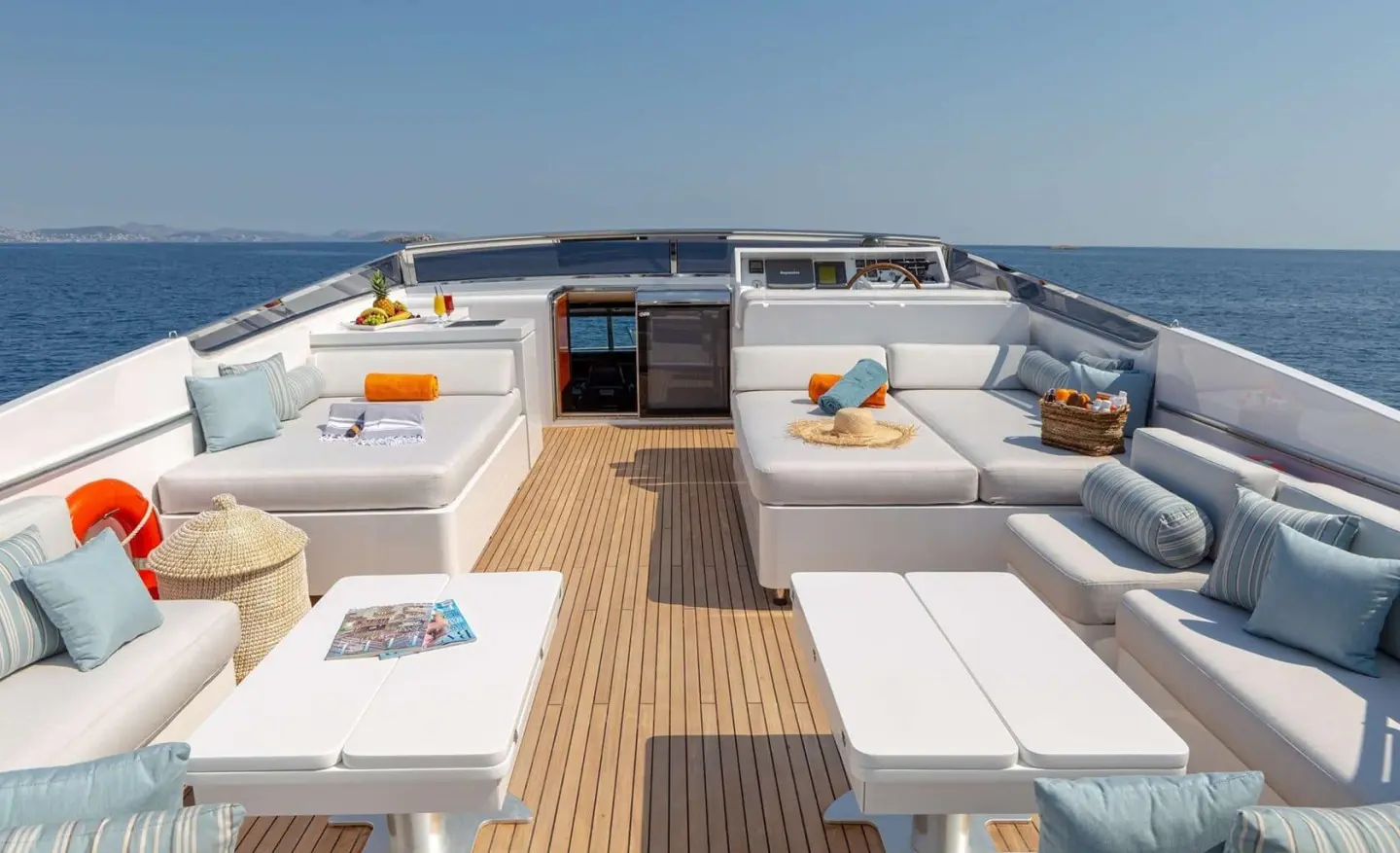 Yacht Grace deck with sun loungers, cushions, and rope railing at sunset