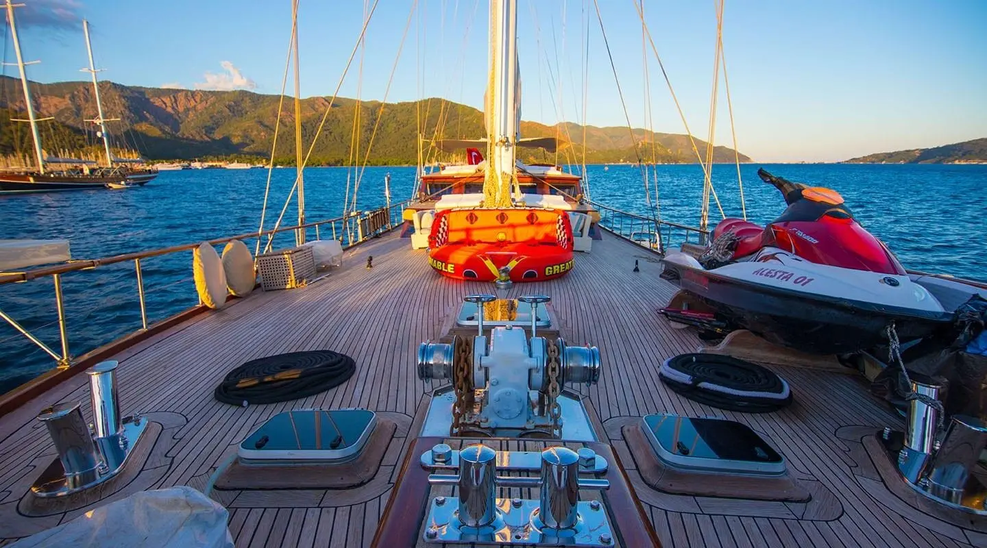 Grande Mare yacht deck view at sunset with orange lifebuoy and sleek rails