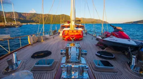 Grande Mare yacht deck view at sunset with orange lifebuoy and sleek rails