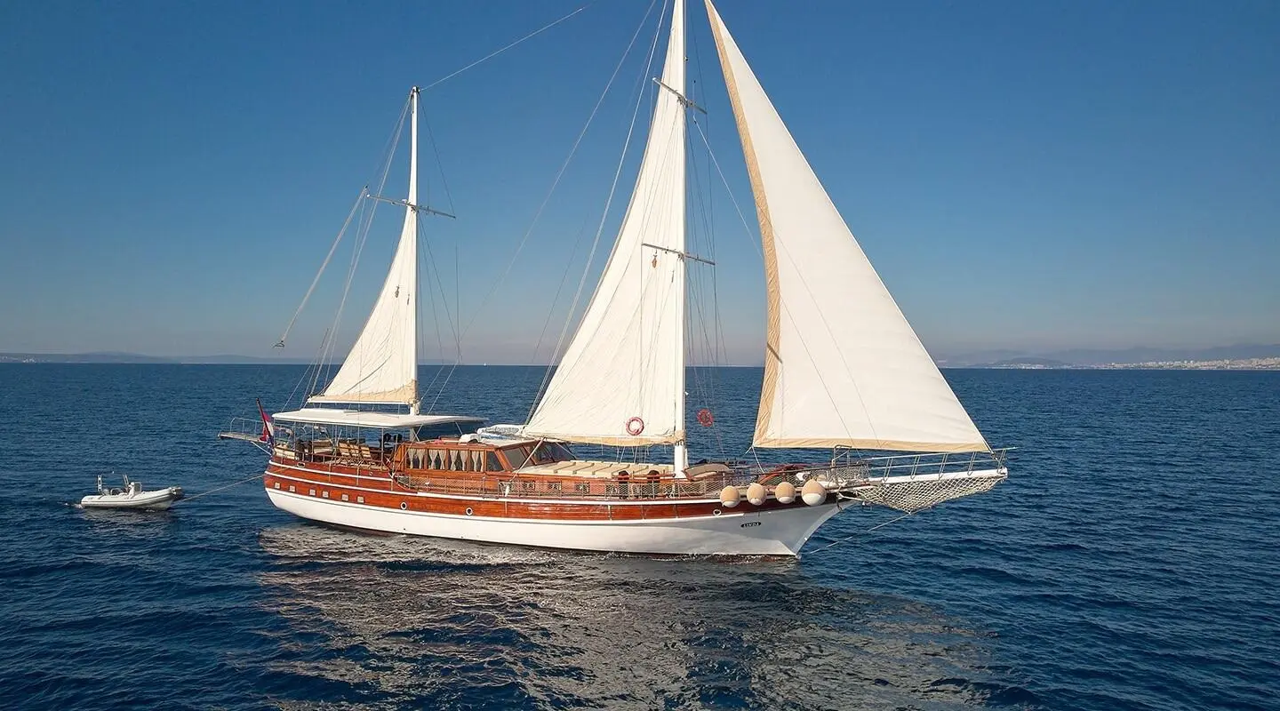 Linda luxury 32m sailing yacht with white sails on calm blue sea