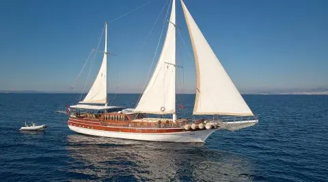 Linda luxury 32m sailing yacht with white sails on calm blue sea