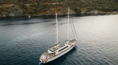Gulet Queen Of Makri yacht anchored in calm water by a quay