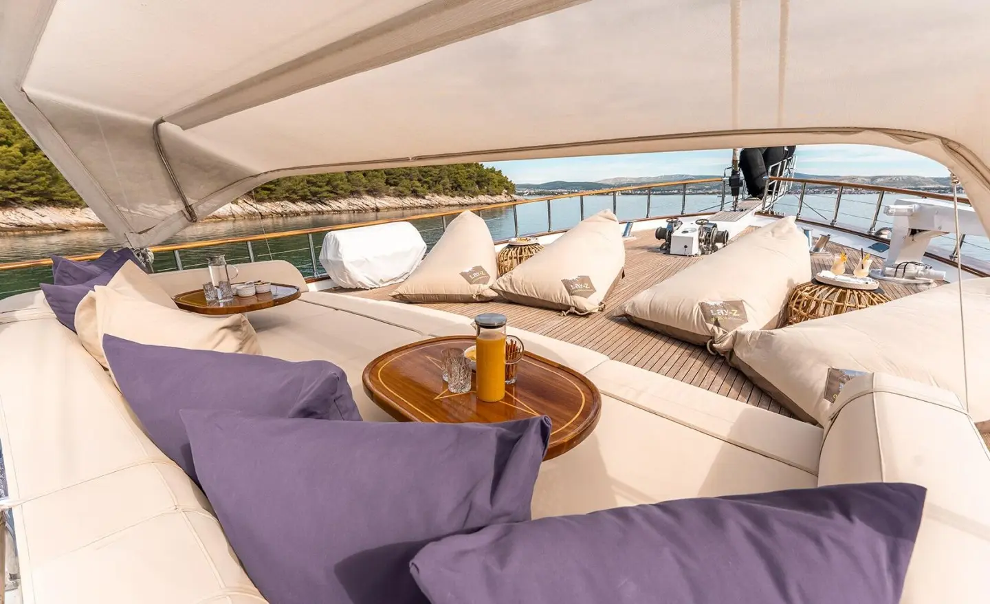Alessandro I luxury gulet yacht exterior deck with cushioned seating at sunset