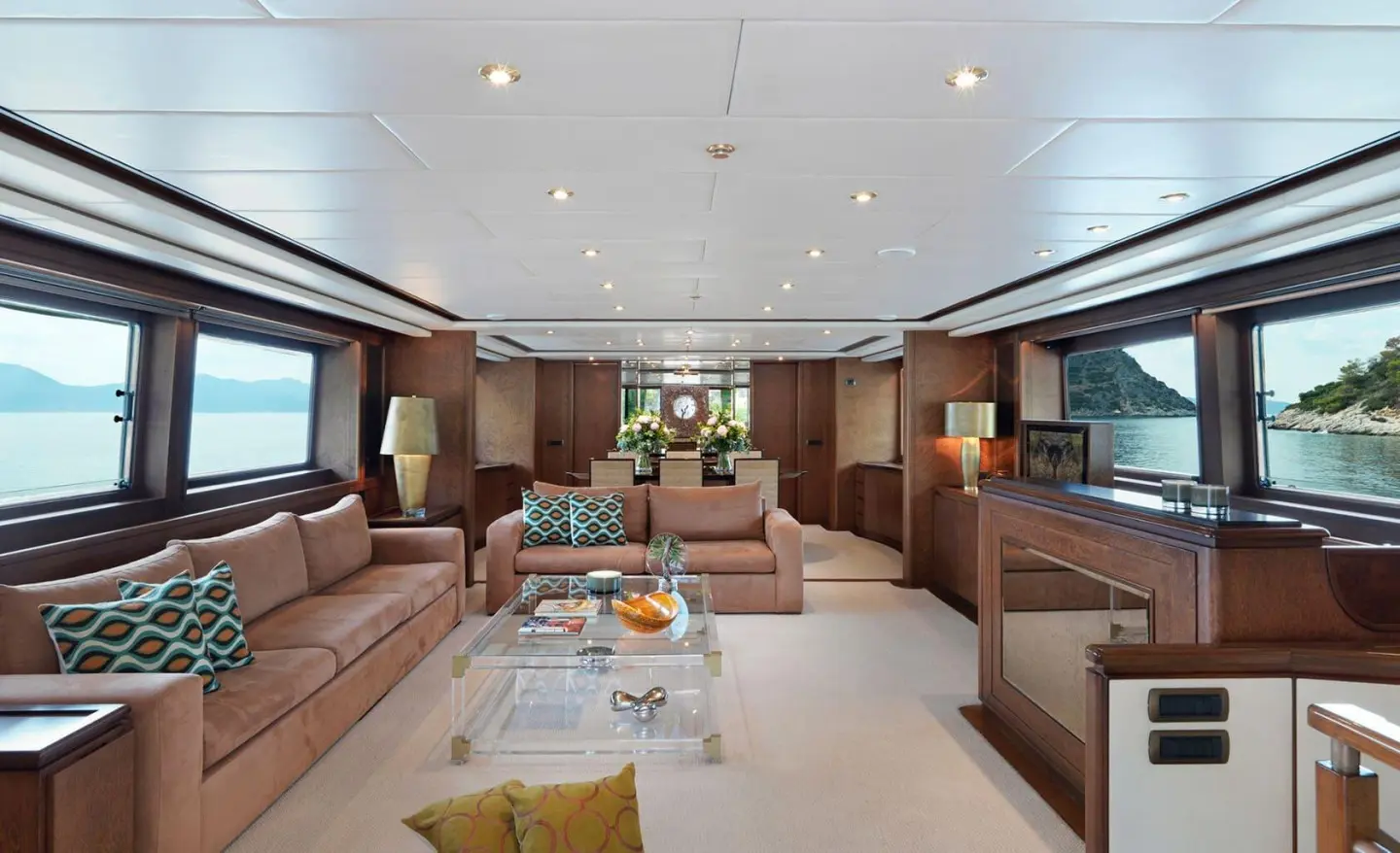 Interior of Idylle motor yacht saloon with beige seating and coffee table
