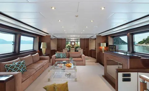 Interior of Idylle motor yacht saloon with beige seating and coffee table