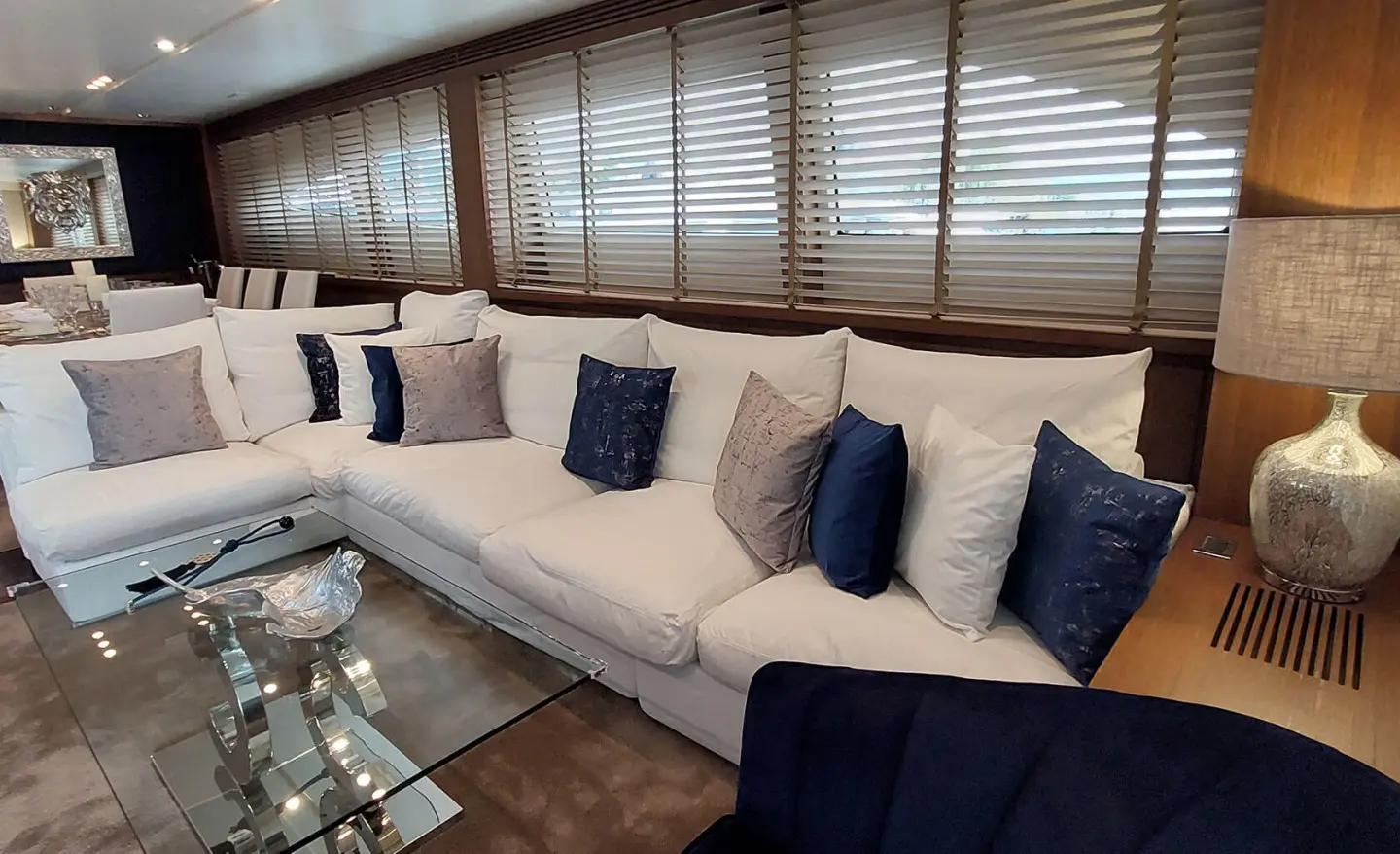 Miraval motor yacht saloon with beige sofa and blue cushions