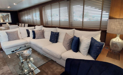 Miraval motor yacht saloon with beige sofa and blue cushions