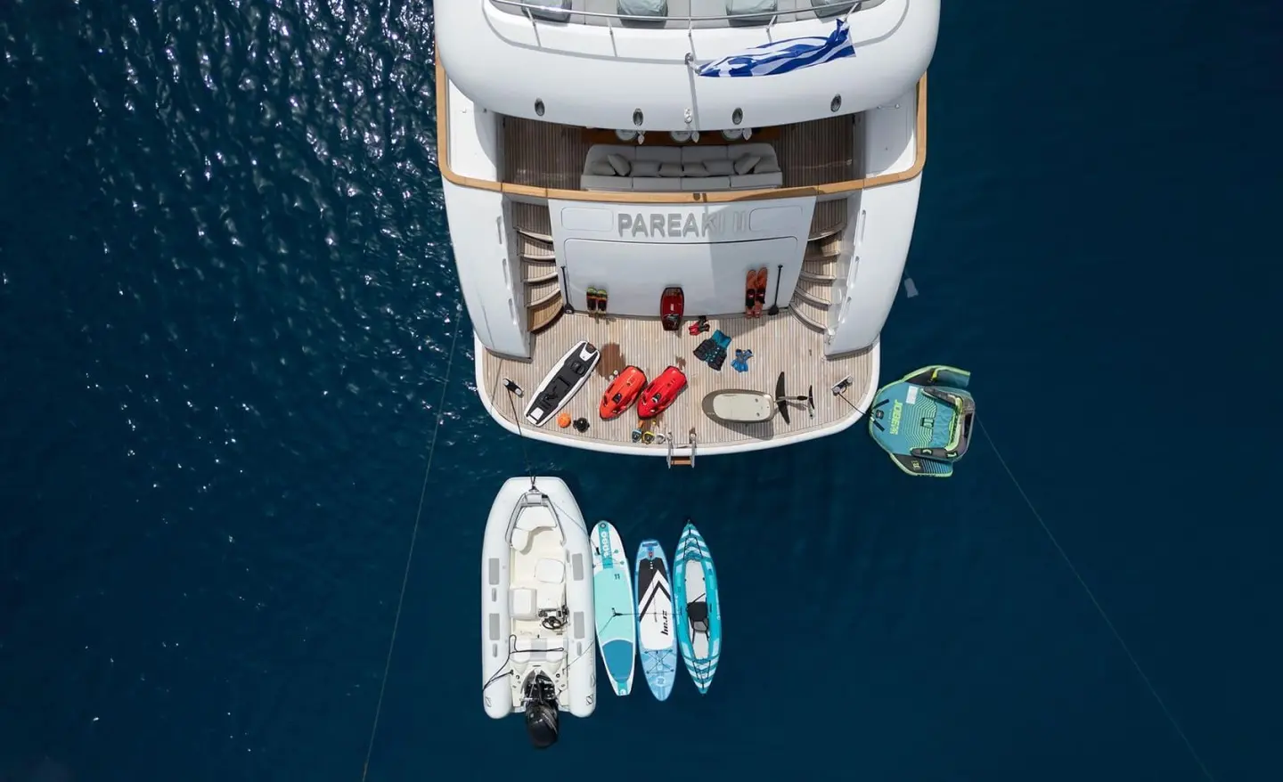 Pareaki II yacht charter seen from above with dinghies on stern swim platform