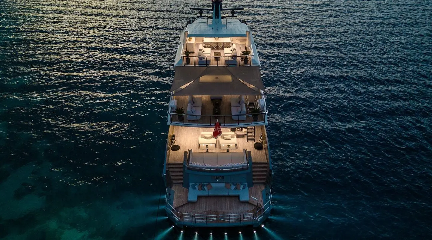 Top-down view of Illusion II yacht at sea during sunset, calm water