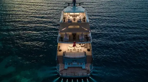 Top-down view of Illusion II yacht at sea during sunset, calm water