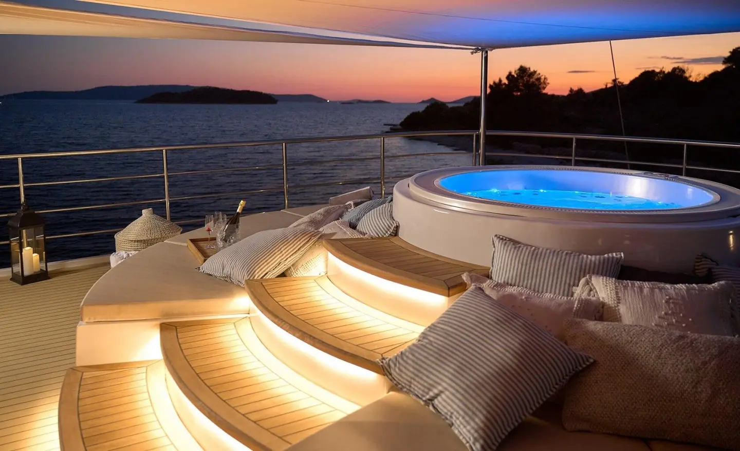 Bellezza yacht with jacuzzi and sunbathing area on deck at twilight