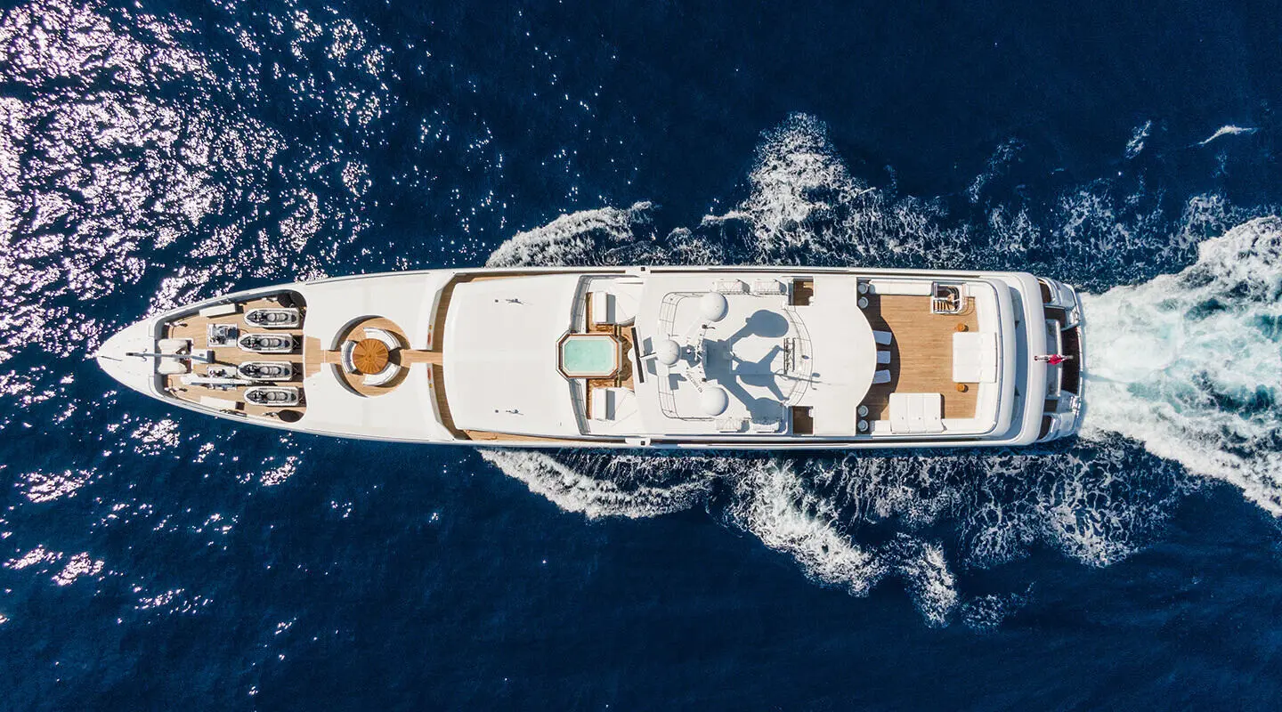 Top-down view of the yacht on the sea with an open deck and seating areas
