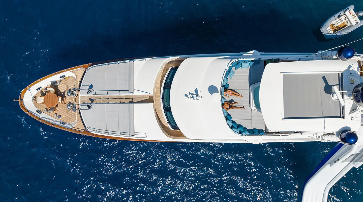 Aerial view of Amadea yacht anchored in deep blue sea, white superstructure