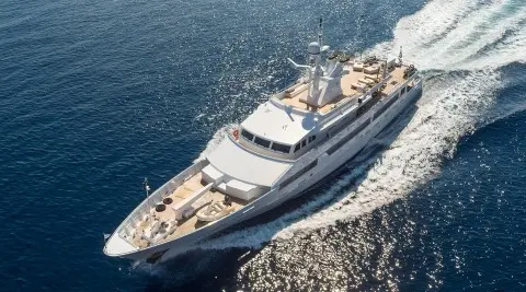 Aerial view of a sleek motor yacht named O'Natalina cruising on blue sea