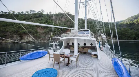 Kayhan 4 yacht helm area on deck with seating and sunset glow