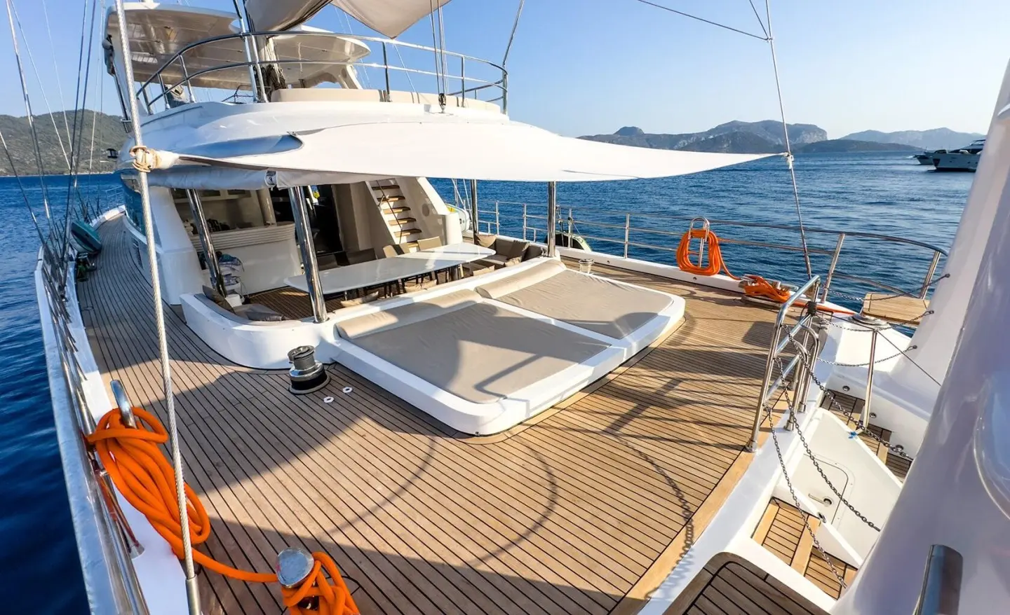Angelo III yacht deck at sunset with loungers and sea view