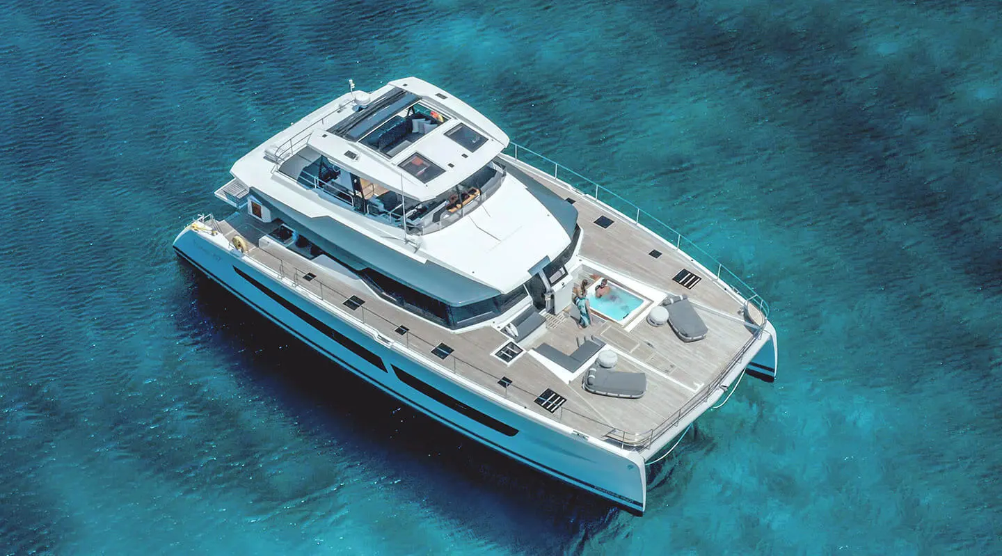 A luxury yacht D2 anchored in clear turquoise water at sunset