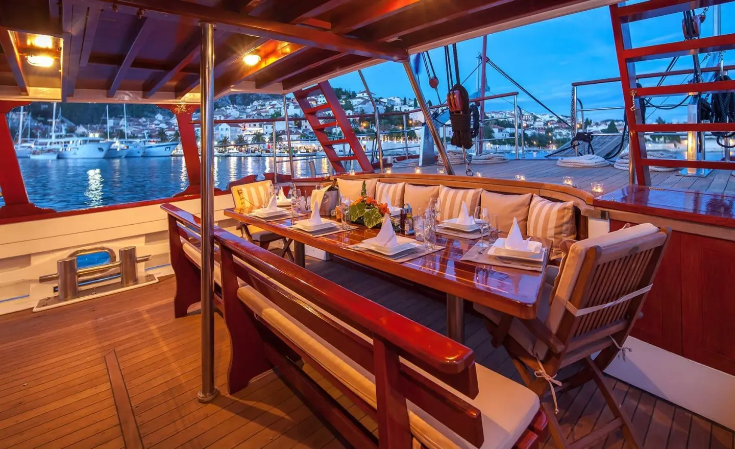 Dining area on aft deck of Romanca gulet with table set under shade