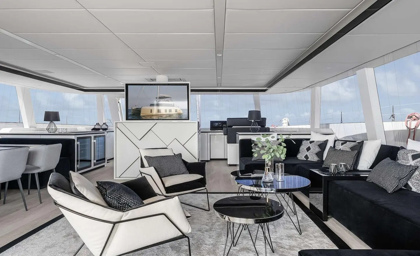 Luxurious yacht deck seating area with glass table and sunset view
