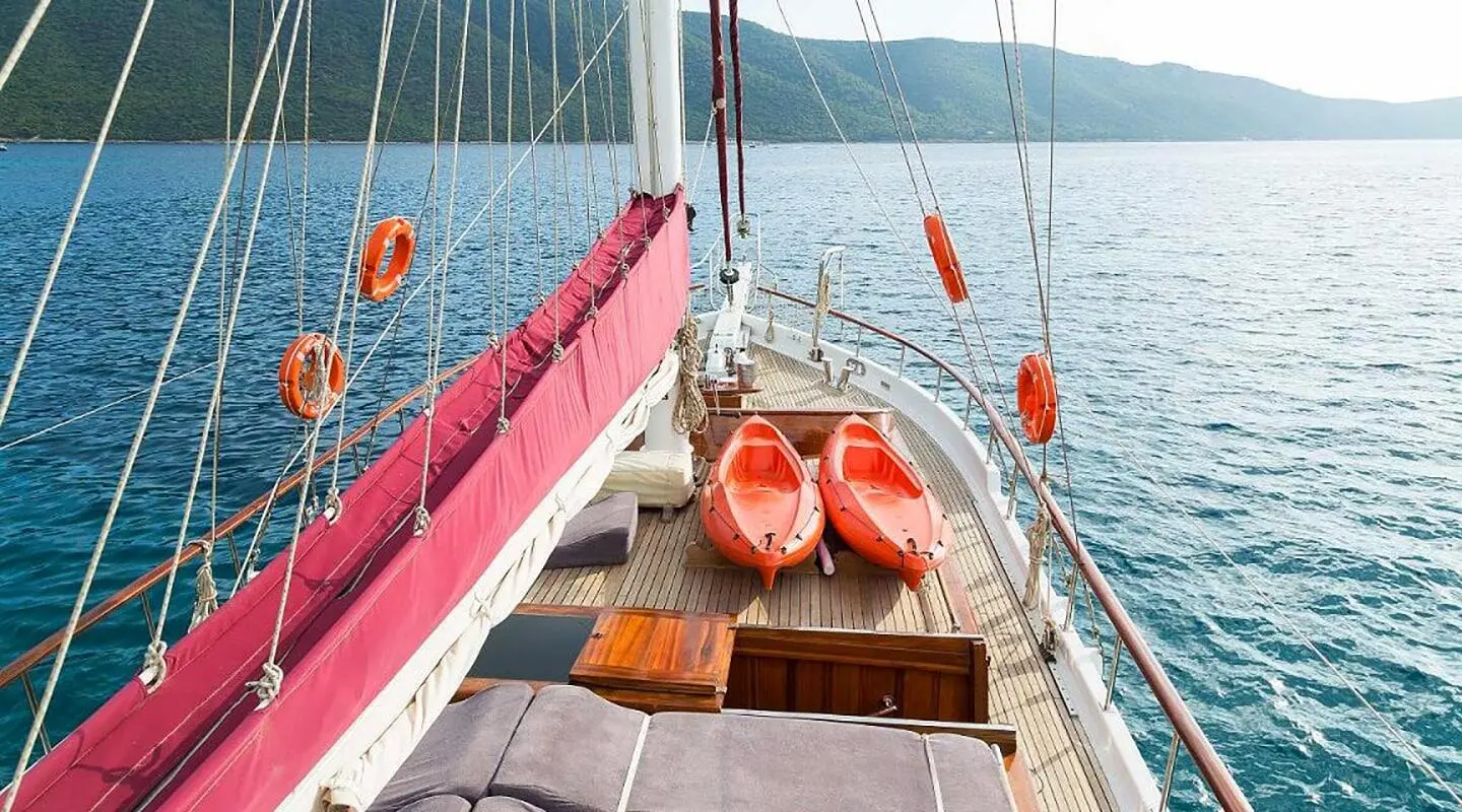 Primadonna yacht deck at sunset with cushioned seating and ropes