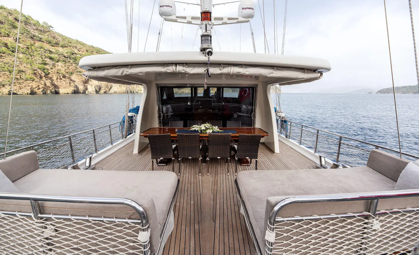 Kayhan 3 yacht deck with sun loungers and open cockpit at sunset