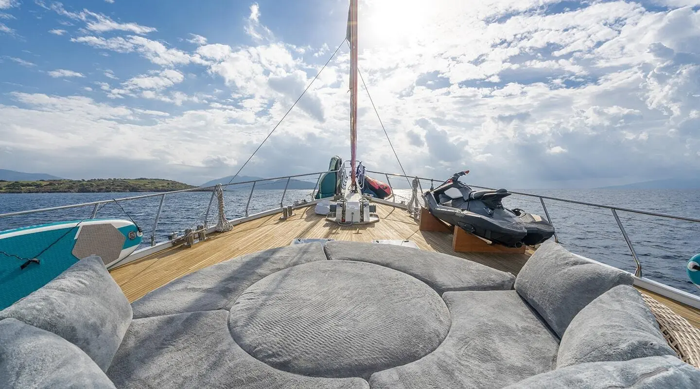 View from the bow of a luxury yacht named Lucky You at sunset with other boats nearby