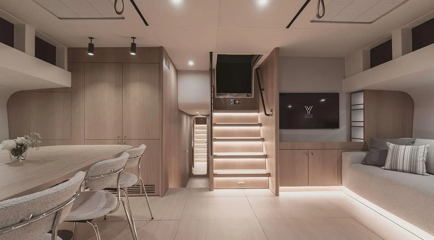 Nadamas yacht salon interior: wood accents, stairs center, seating area visible
