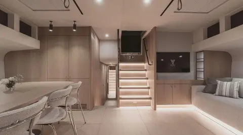 Nadamas yacht salon interior: wood accents, stairs center, seating area visible