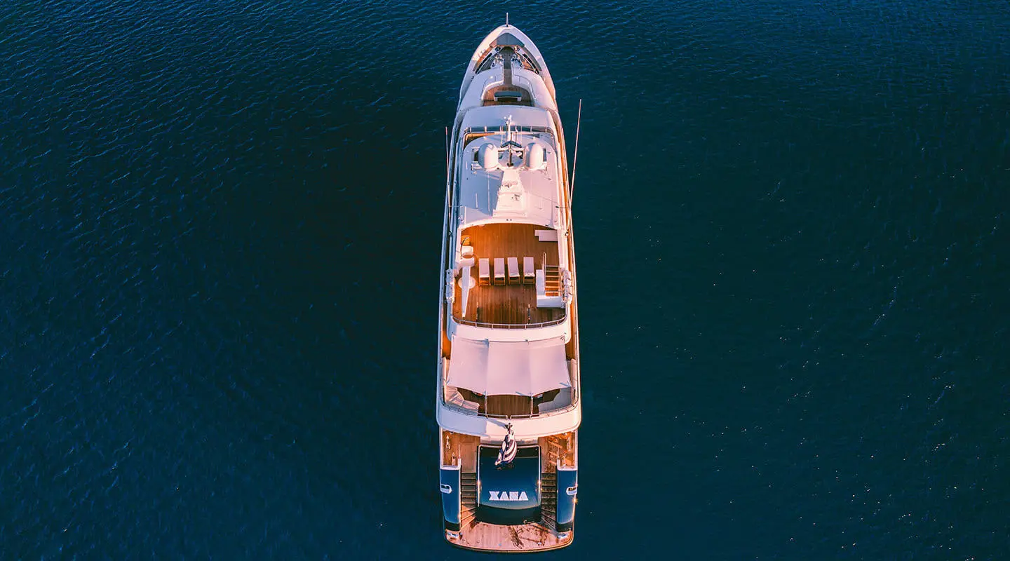 Top-down view of Xana luxury yacht at sea with deck seating and sun loungers