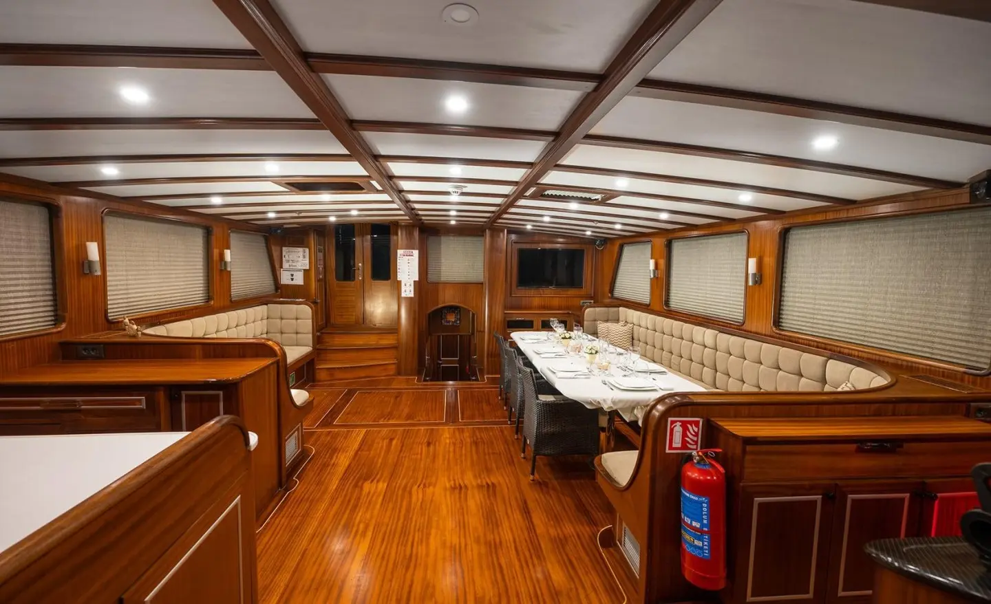 Interior of Estrella De Mar yacht with polished wooden decks and cozy seating.