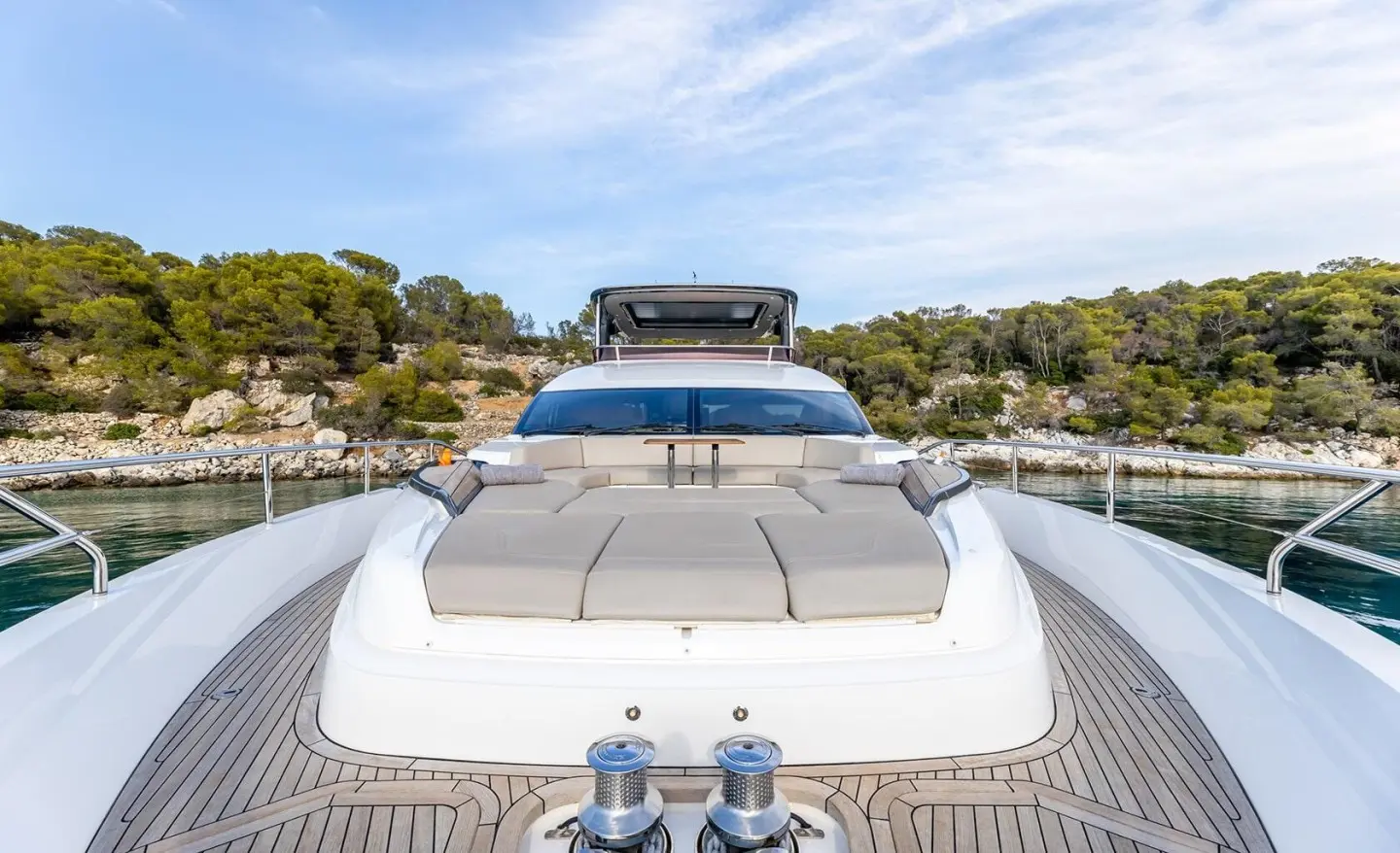 Front view of Vista yacht with beige sunbathing cushions on the deck