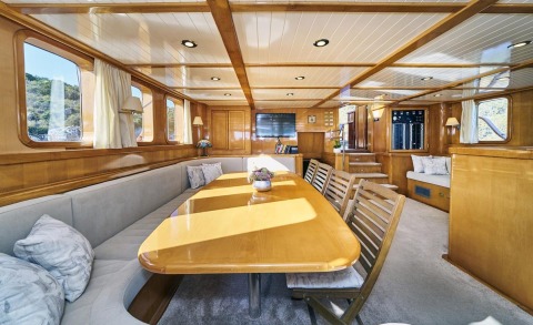 Morning Star interior: polished wood galley and dining saloon with large table and comfortable seating