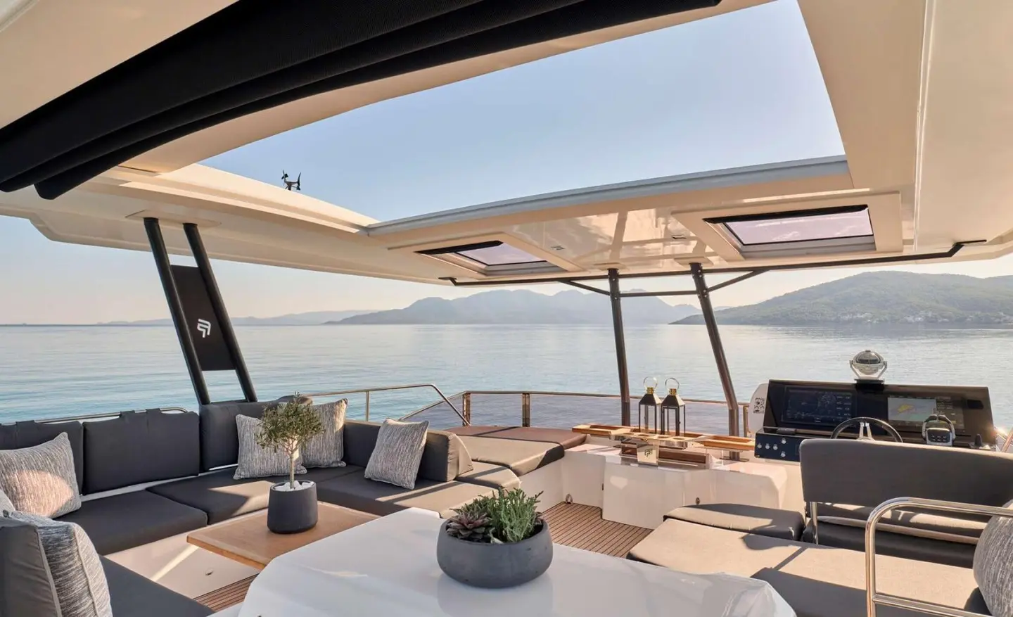 Christal Mio yacht charter deck view with seating, cushions, and shaded area