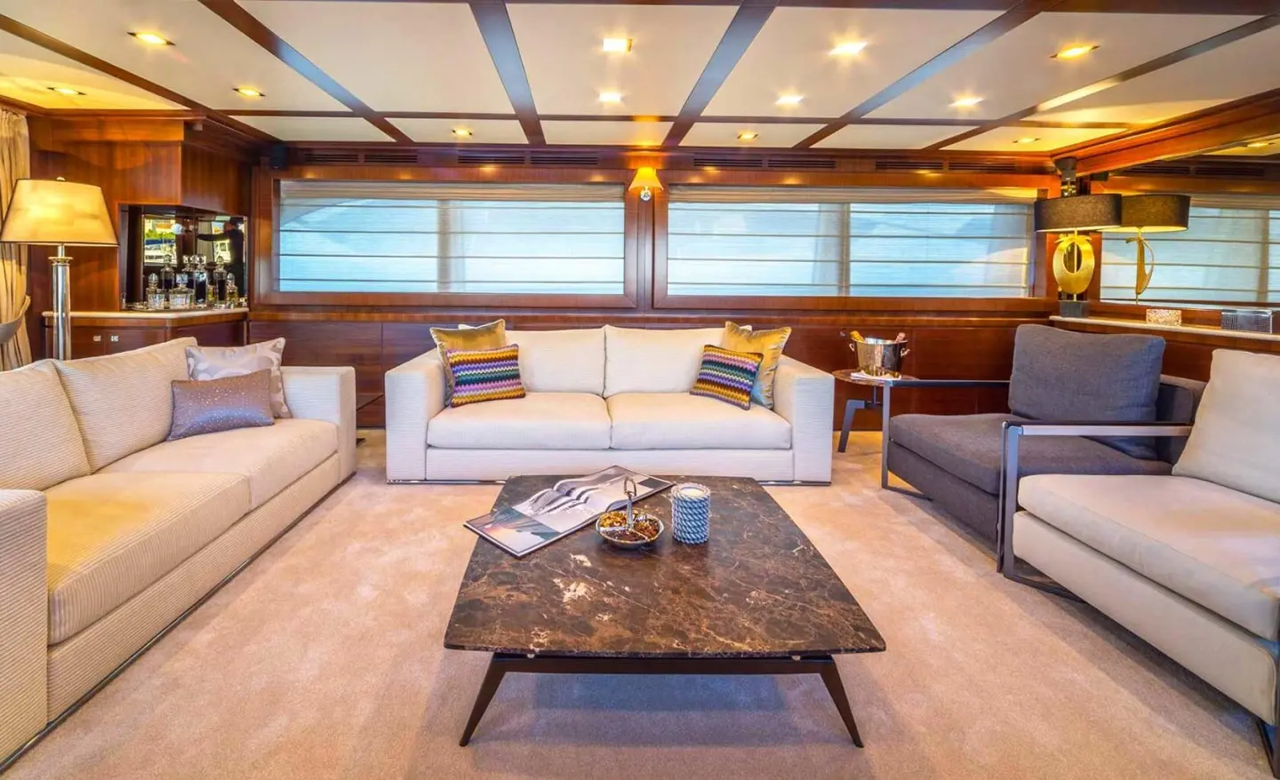 Interior of Seventh Sense yacht saloon with white sofas and dark coffee table