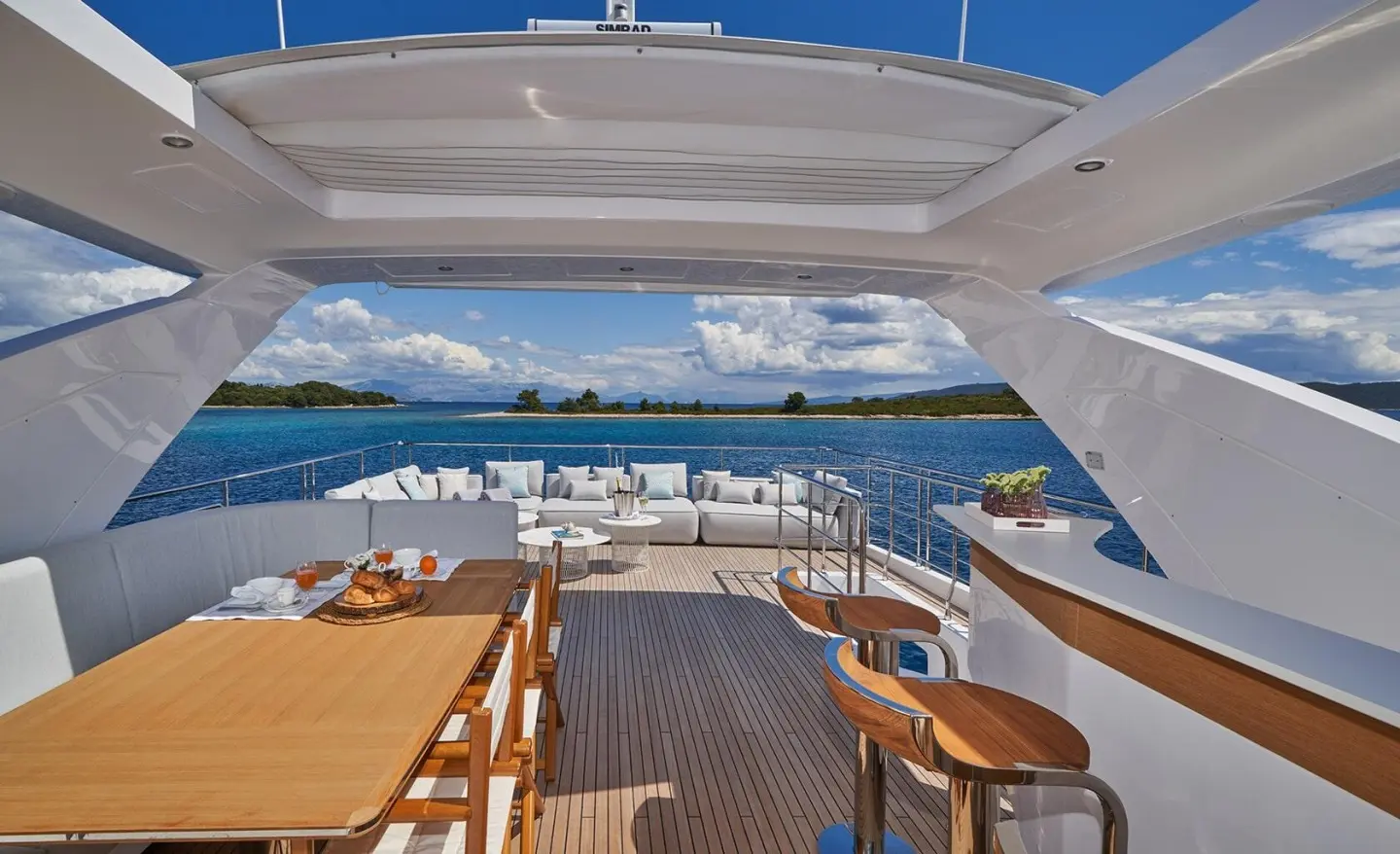 Aluminia Too yacht deck view with seating, helm, and ocean backdrop