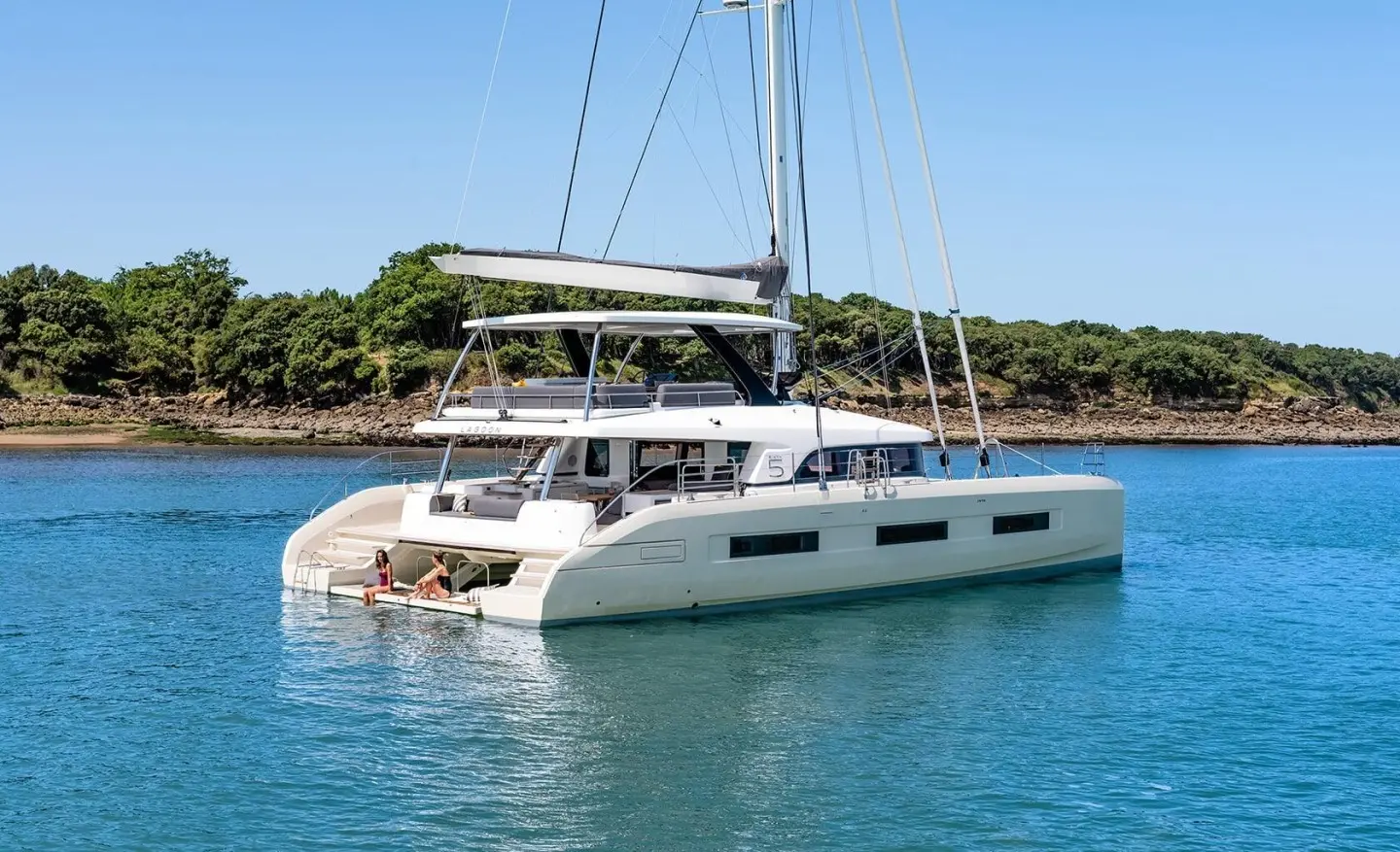 Daiquiri luxury catamaran anchored in tranquil turquoise waters with sunlit deck seating