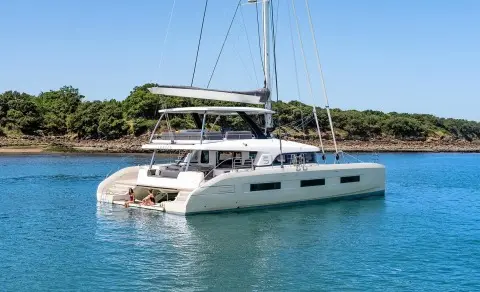 Daiquiri luxury catamaran anchored in tranquil turquoise waters with sunlit deck seating